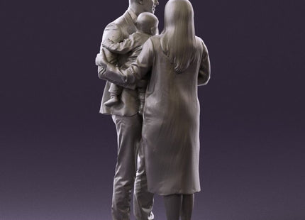 Young Couple Posing With Child Figure